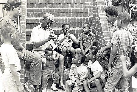 In New York the stoop performs a similar social function as the southerner’s porch, a place to entertain, to greet, to hold court. “Through the years, Louis entertained millions, from heads of state and royalty to the kids on his stoop in Corona.” – Louis Armstrong House Museum